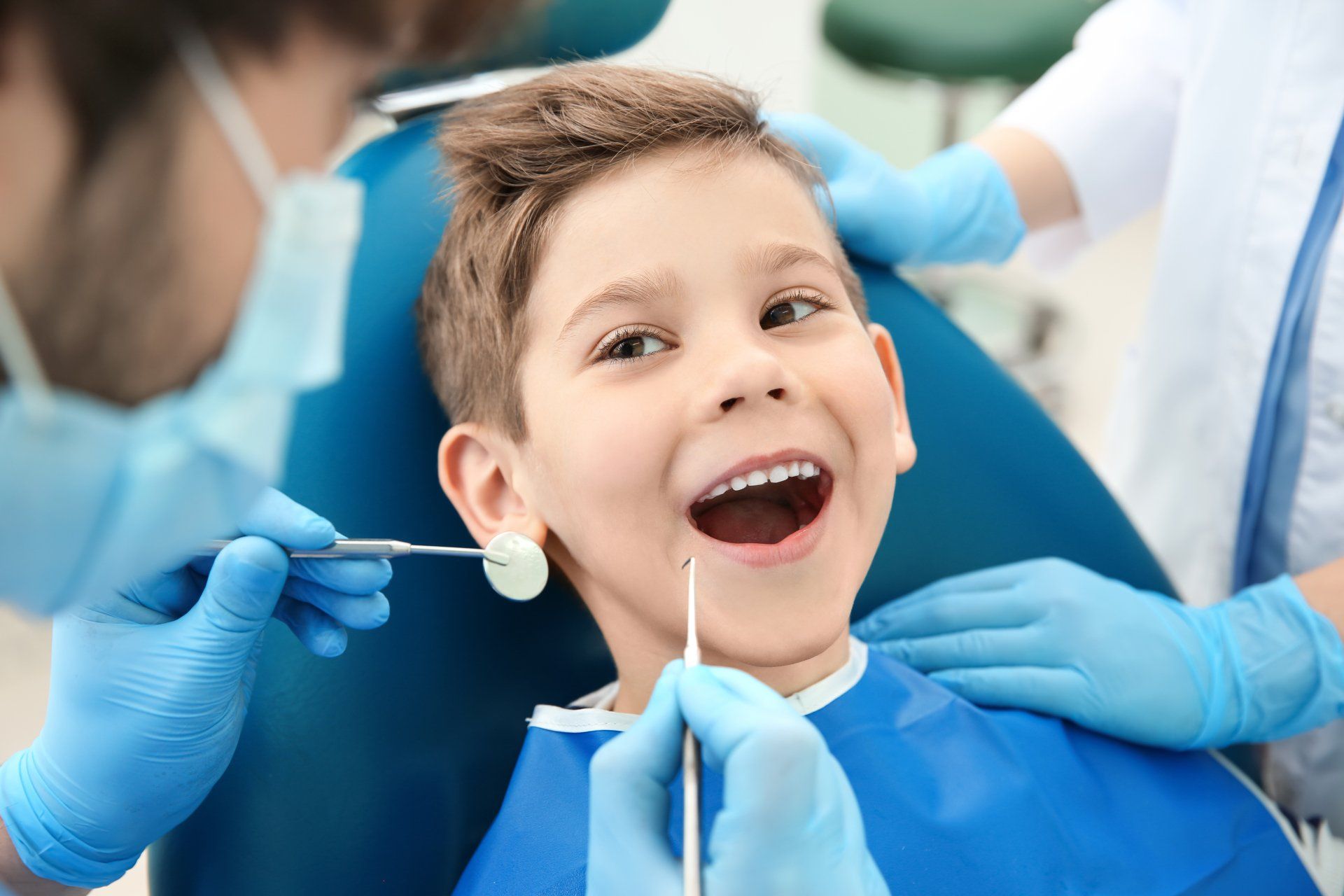 stock-photo-dentist-examining-little-boy-s-teeth-in-clinic-663132562-1920w.jpg